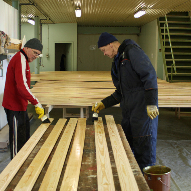 Vilhjálmur Agnarss og Garðar Helga að bera olíu á panel.