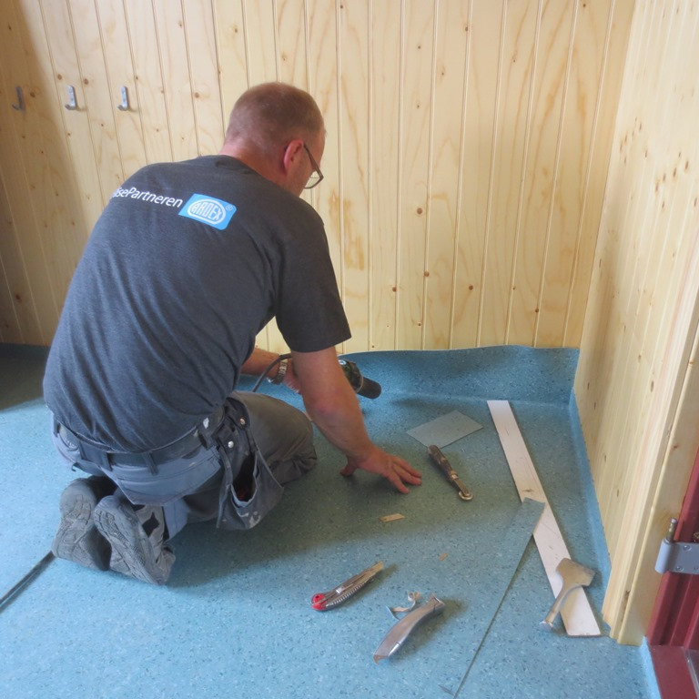 Dúkameistarinn að störfum í forstofu